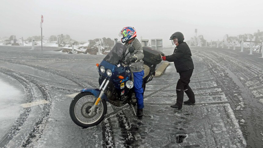 Motorcyclists on a snow covered Mount Wellington.