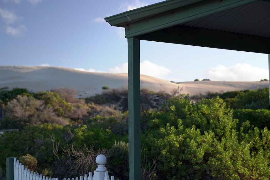 Looking towards nearby sand dunes from the back of a house.