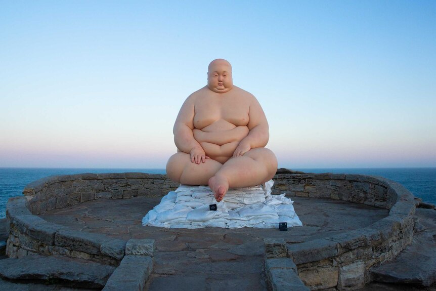Sculpture “Horizon” by sculptor Mu Boyan features a heavily overweight man.