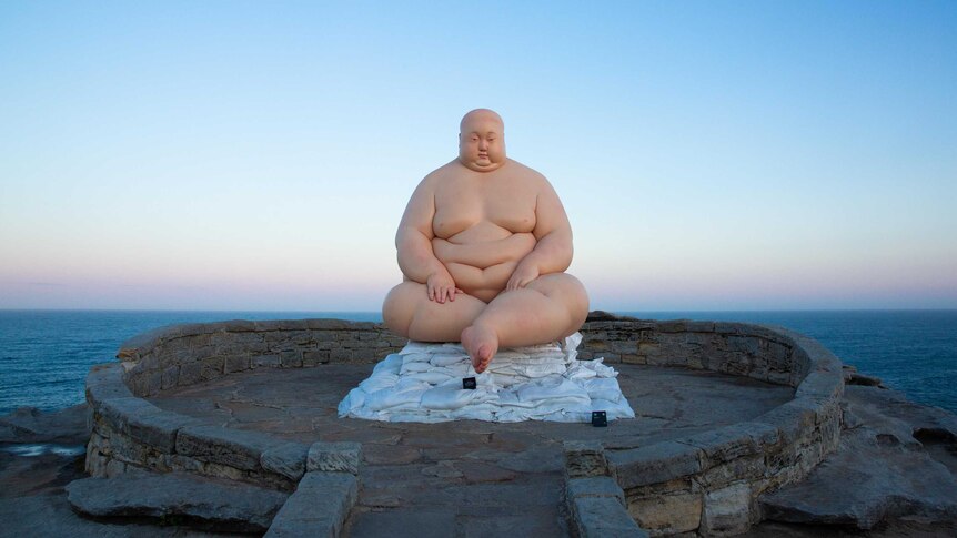 Sculpture “Horizon” by sculptor Mu Boyan features a heavily overweight man.