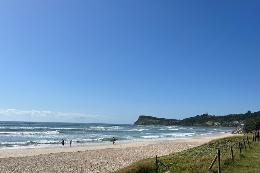 A sandy beach with the Lennox headland in the background.
