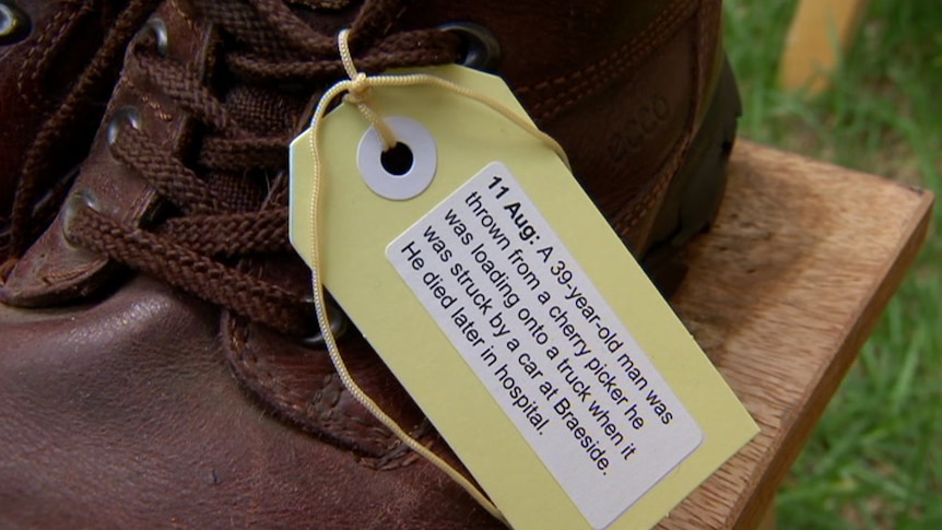 A shoe with a tag on it describing the circumstances of a worker's death.