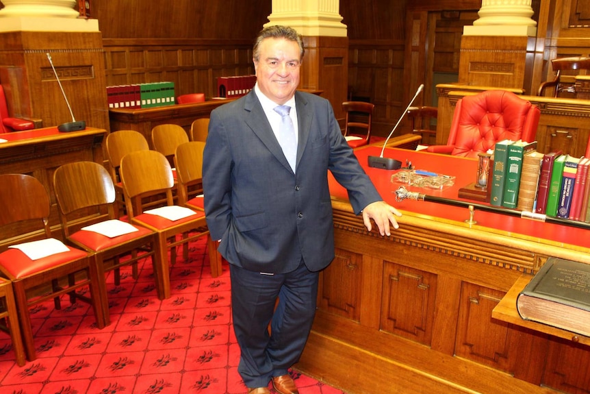 A man in a suit standing in parliament