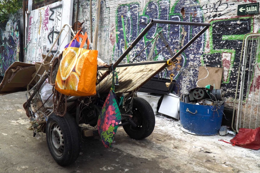 A carrocas, or cart, with rubbish on it and bags hanging from it, on a street in Sao Paulo.