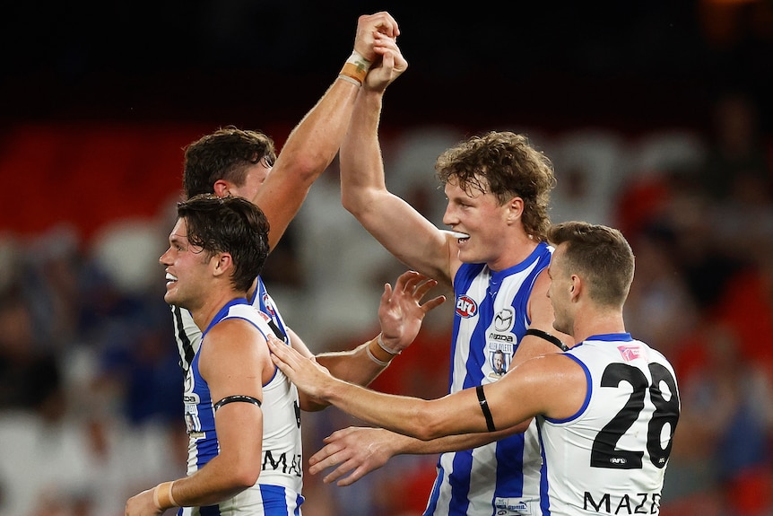 Nick Larkey high-fives a teammate while smiling