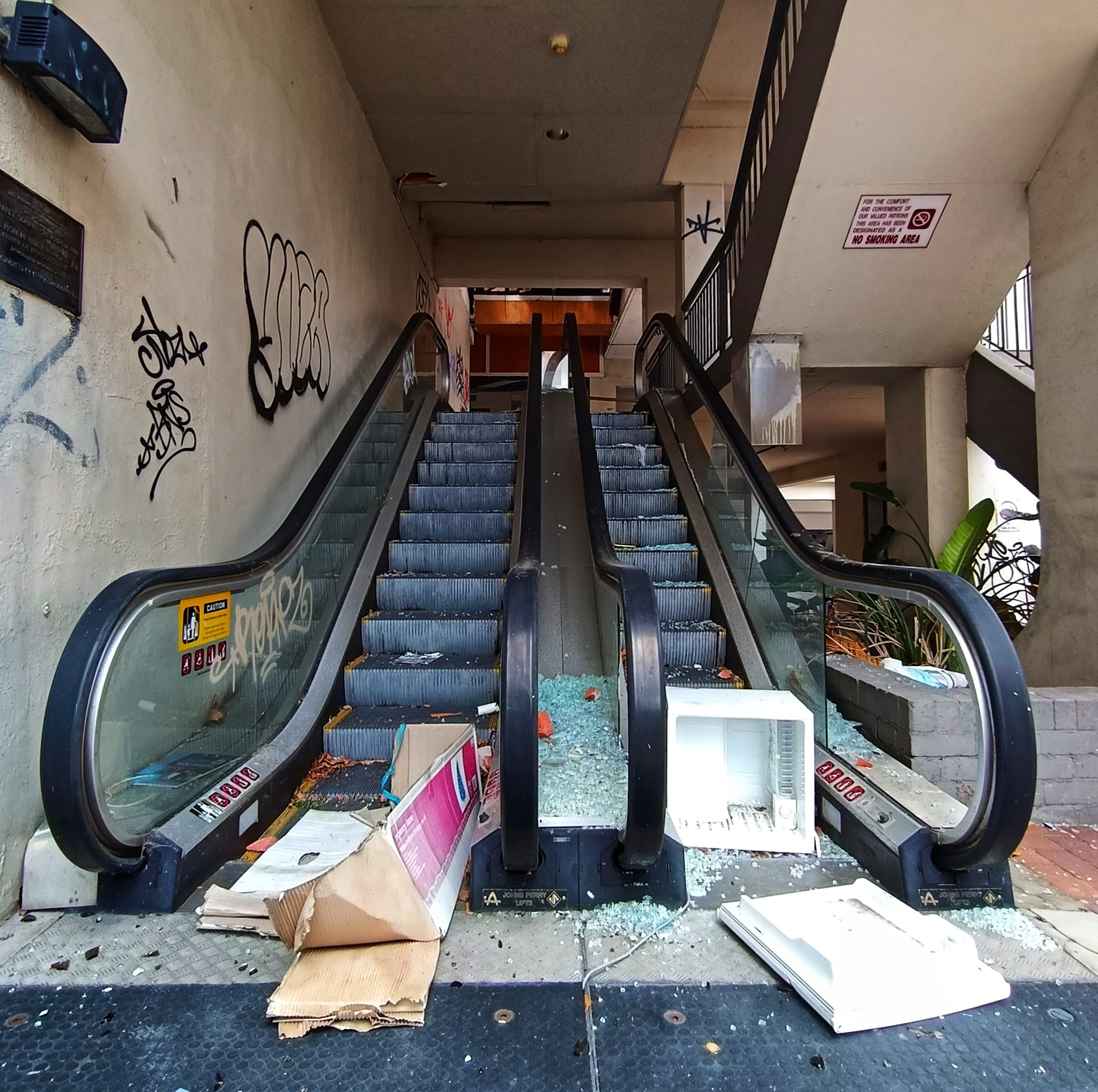 A broken escalator with rubbish.