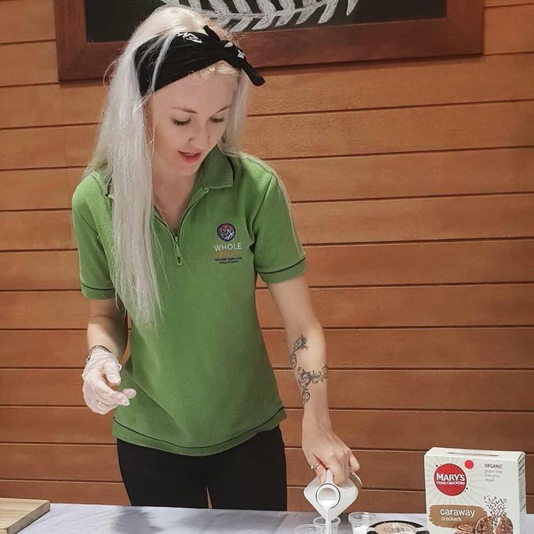 Toyah Cordingley pours some liquid from a bottle while working at a stall outside her workplace.