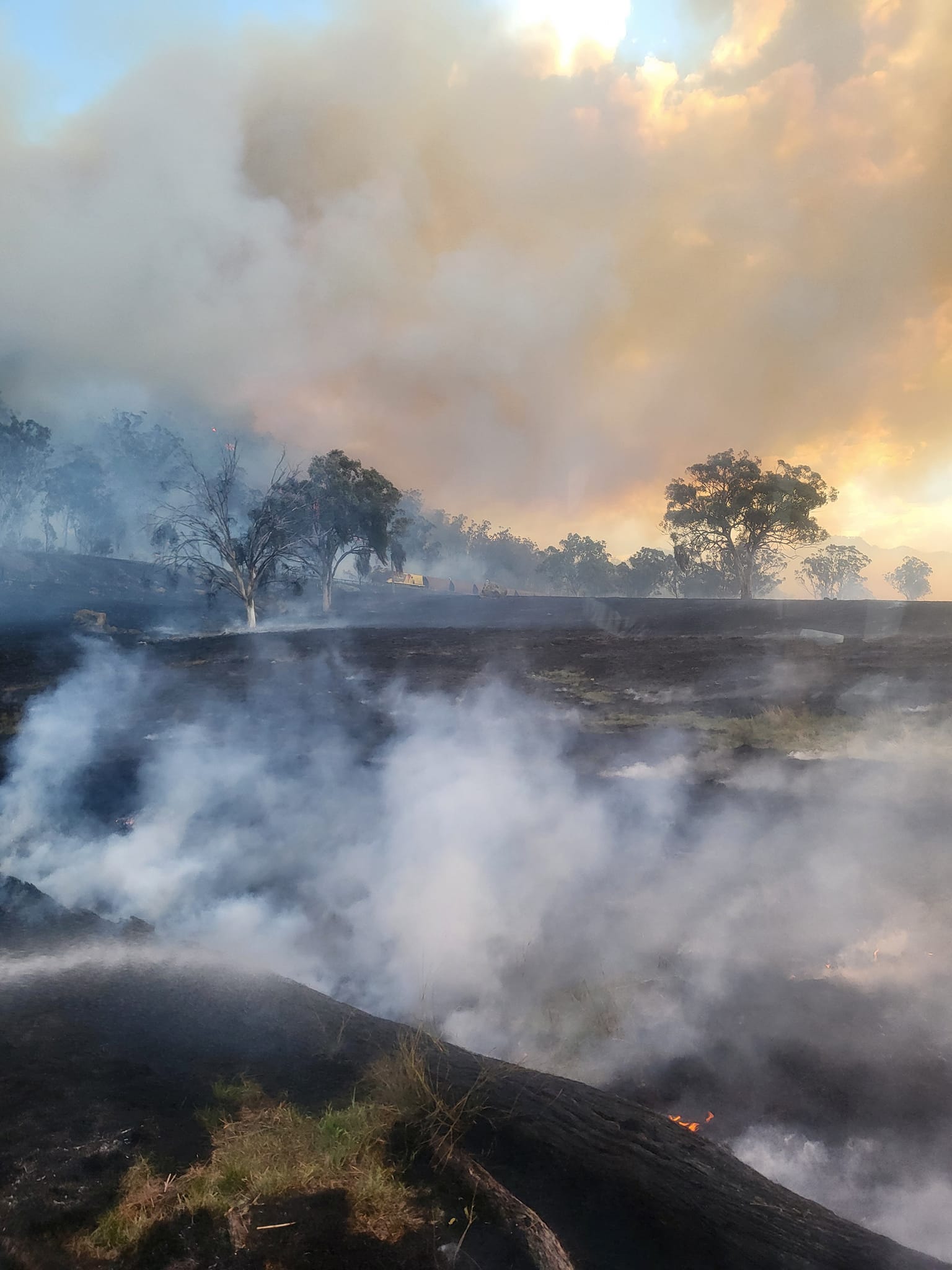 Smoke hanging over a charred field