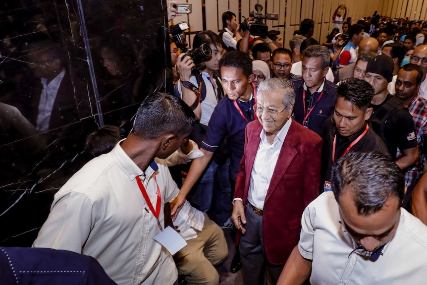 Mahathir Mohamad leaves the room during celebrations at a hotel in Kuala Lumpur