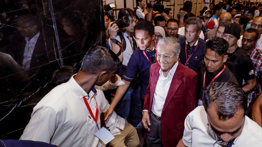 Mahathir Mohamad leaves the room during celebrations at a hotel in Kuala Lumpur