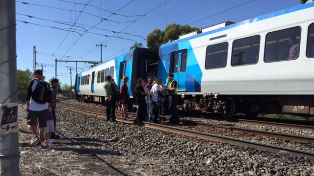 People getting off the train, which had derailed.