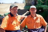 Two farmers in front of harvester at Bulla Burra Farms at Loxton, SA.