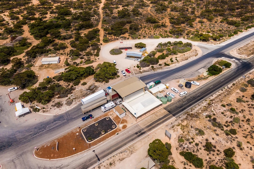 An aerial image taken from a drone showing trucks and cars queued at the Eucla WA border checkpoint.