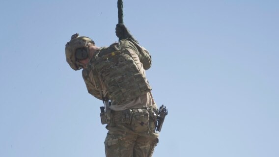 Prince Harry fast ropes during a counter-terrorism exercise.