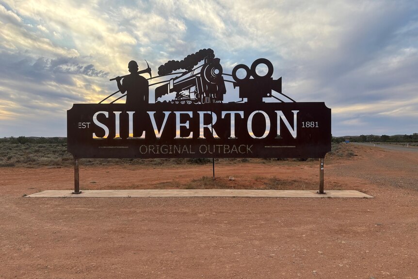 A sign reading ' Silverton' against a cloudy sky