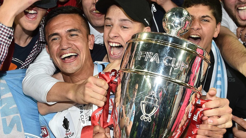 Tim Cahill celebrates with FFA Cup trophy with fans