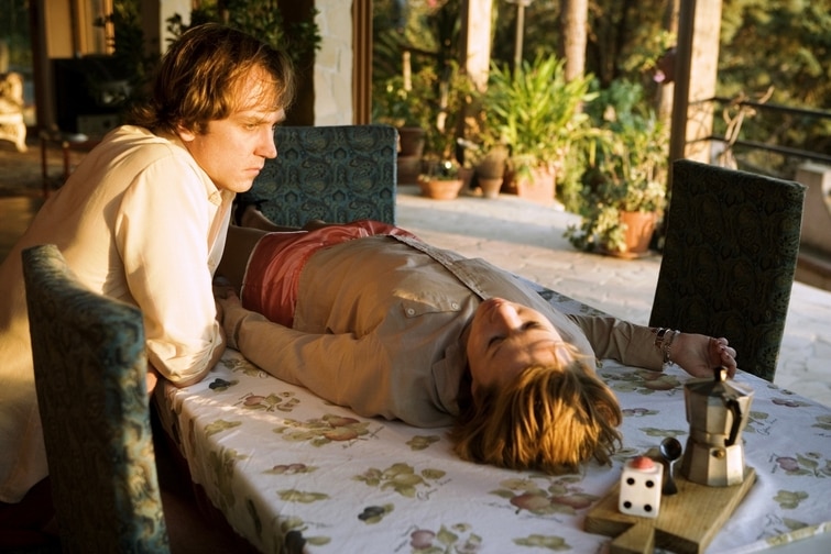 A still from German film Everyone Else a young woman lies on a table and a man sits looking at her