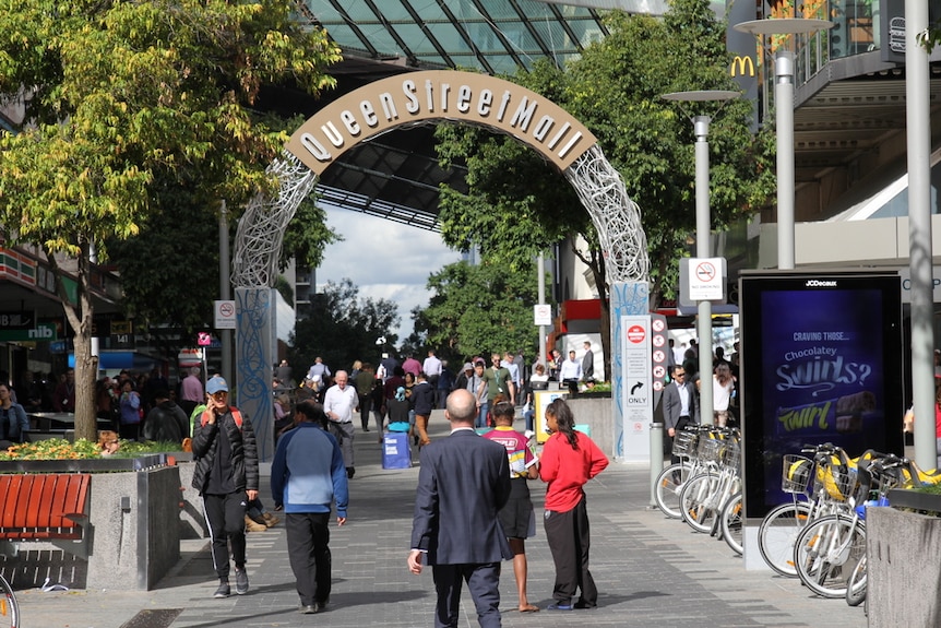 People walk through the Queen Street Mall arch in Brisbane CBD in June 2018.