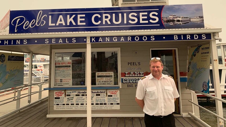 James Peel, a fourth generation boat tour operator standing in front of business.