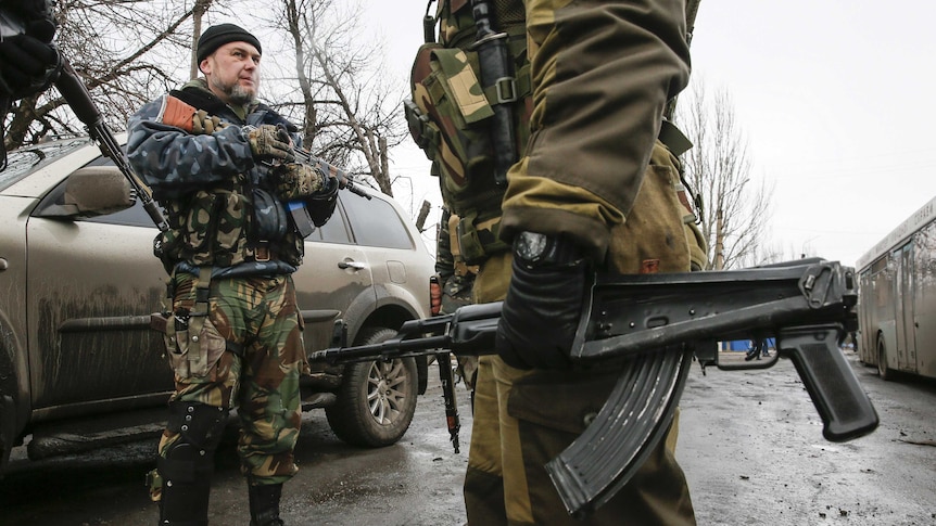 Members of the armed forces of the separatist self-proclaimed Donetsk People's Republic stand guard at a street in Vuhlehirsk, Donetsk region February 6, 2015.