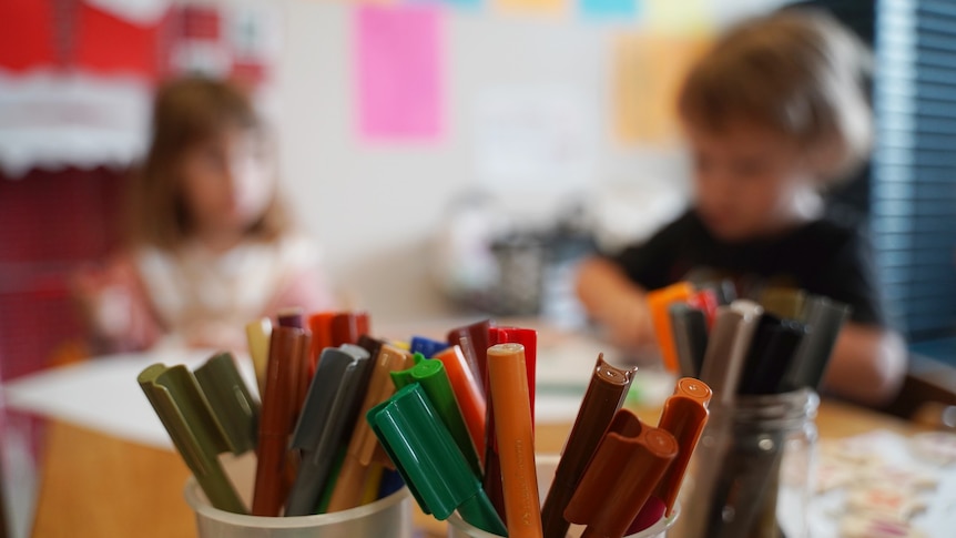 Colourful pencils on a desk in a childcare centre.