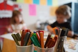 Colourful pencils on a desk in a childcare centre.