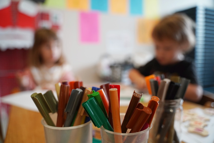 Colourful pencils on a desk in a childcare centre.