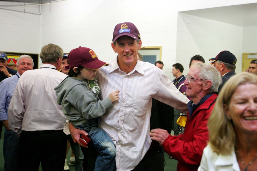 Wayne Bennett and Cyril Connell embrace in the dressing room after another Bronco's win.