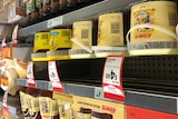 Allowrie honey stacked on shelves in Woolworths, alongside Capilano honey.