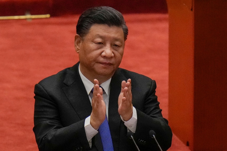 Chinese President Xi Jinping applauds at event