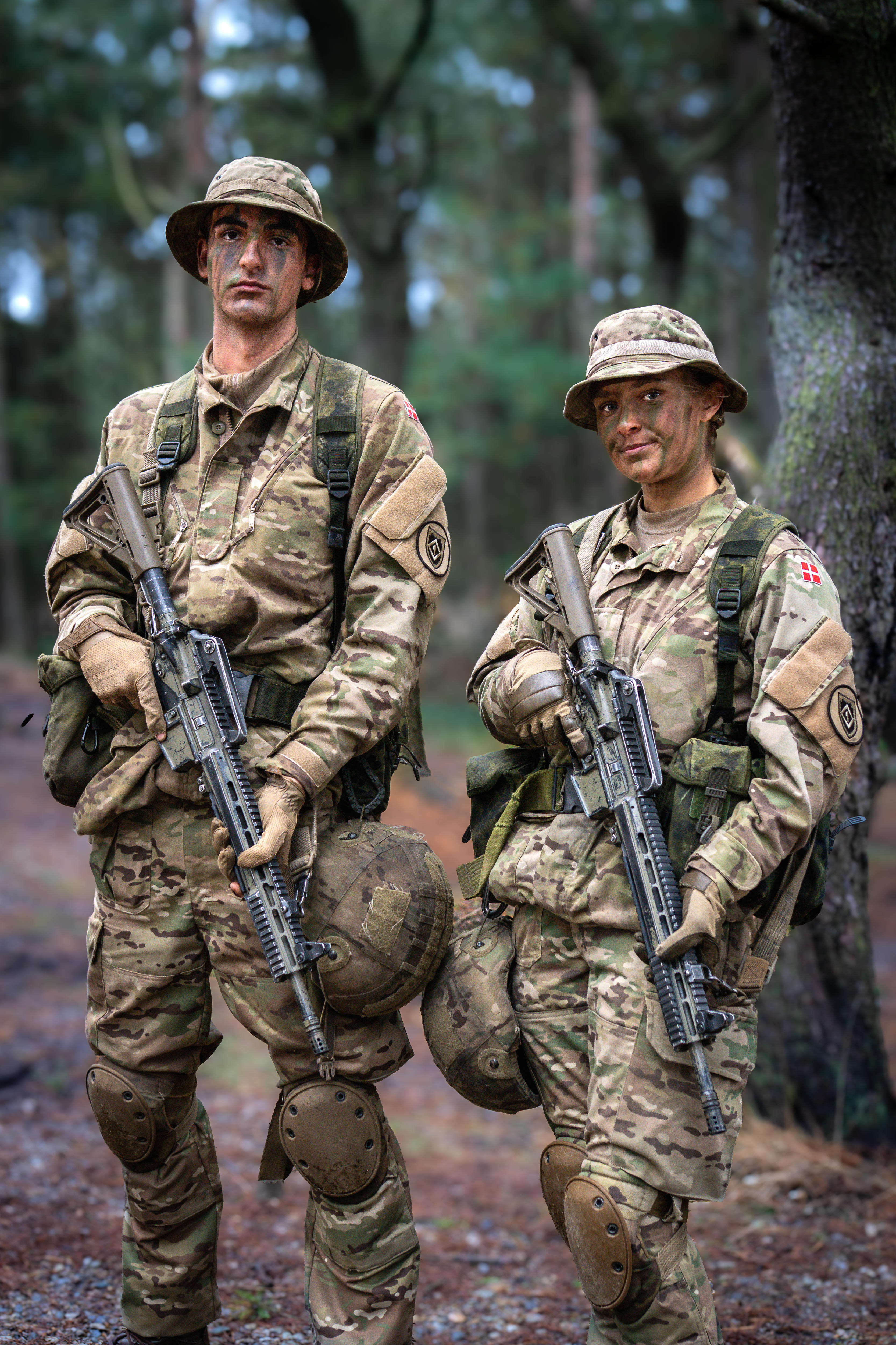 A man and a woman with guns.