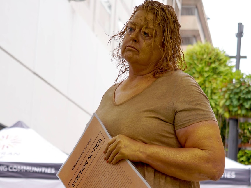 South Australian Welfare Minister Nat Cook in golden body paint at Rundle Mall.