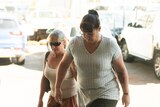 Two middle-aged women walk up the stairs of the NT Supreme Court in Darwin
