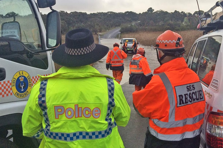 Emergency workers prepare a winch to remove the van from the water