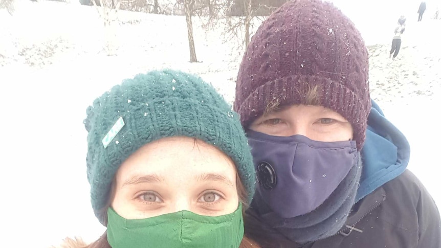 Sarah and Jackson wearing masks in the snow.