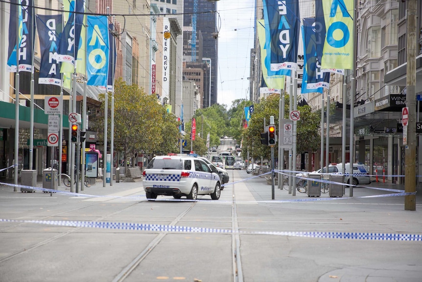 Bourke Street empty aside from trams and police cars