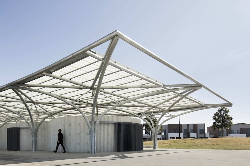A toilet block with a skeletal metal framed roof