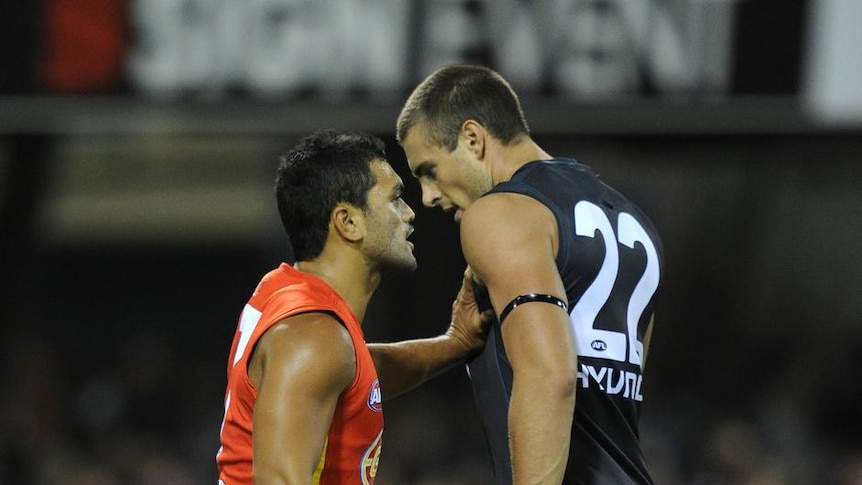 Welcome to the big leagues: Karmichael Hunt had a tough first night in the AFL against the towering Carlton forward line.