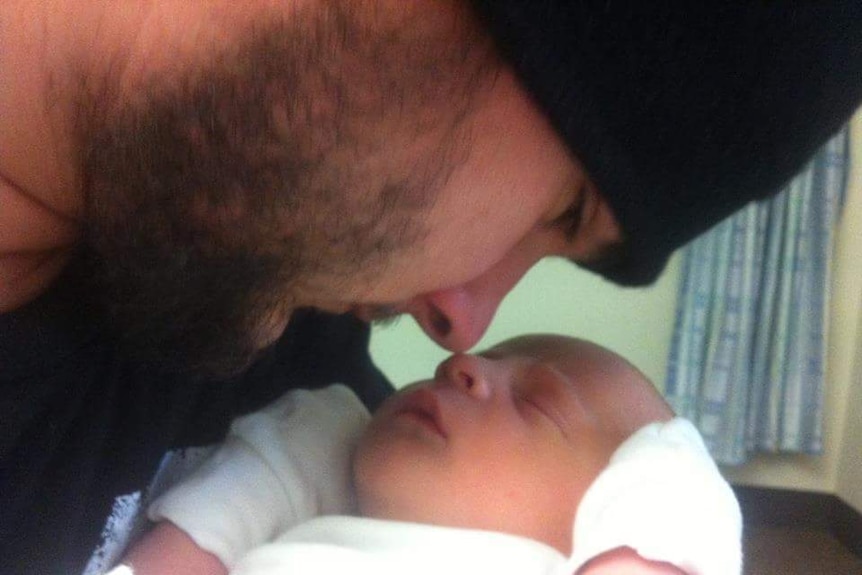 Australian wheelchair rugby player Jake Howe meeting his son Lucas for the first time.