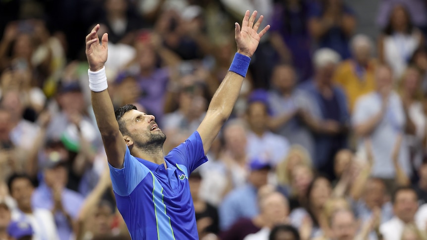 Novak Djokovic holds up his hands