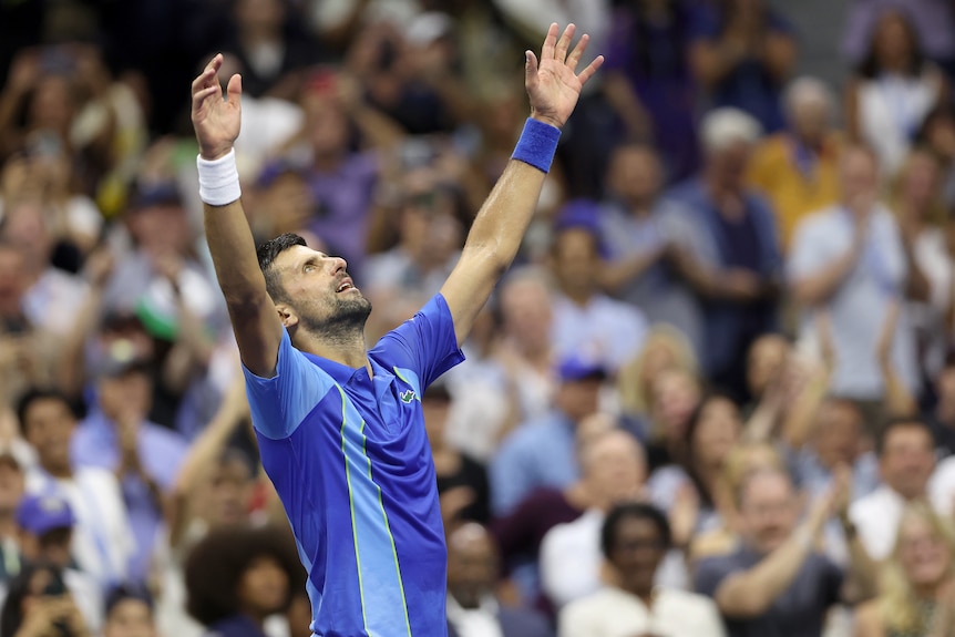 Novak Djokovic holds up his hands