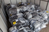 Dozens of bundles of cocaine in a shipping container.