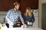 Brenton and Charlotte making tea in the kitchen.