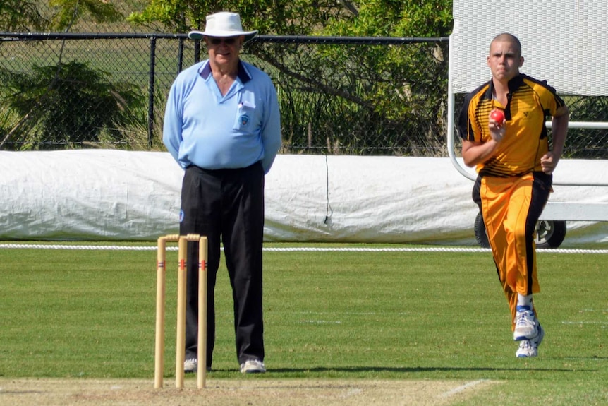 Cooper prepares to bowl on a cricket pitch