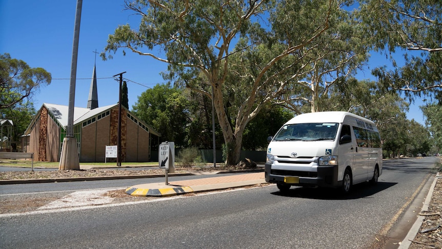 A maxi taxi drives by a Lutheran Church on Gap Road.