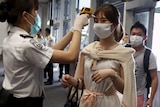 Hong Kong airport staff screen passengers from South Korea