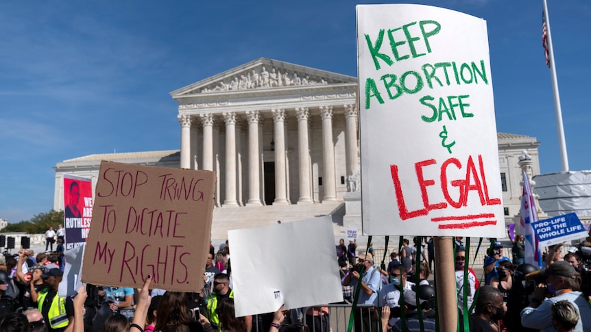 pro choice signs are held up by crowds of women infront of the US Supreme Court in Washington DC