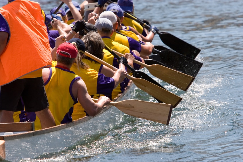 People paddling in a dragon boat race.