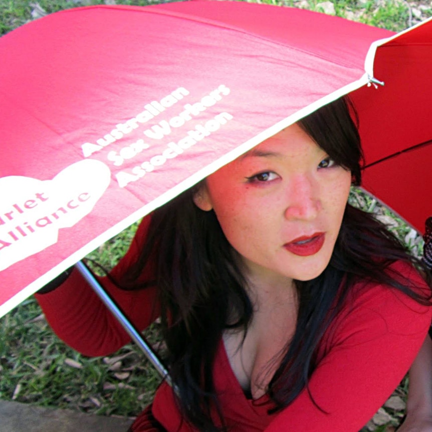 A woman with a red umbrella.