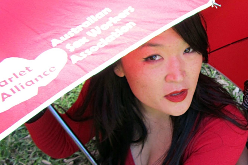 A woman with a red umbrella.